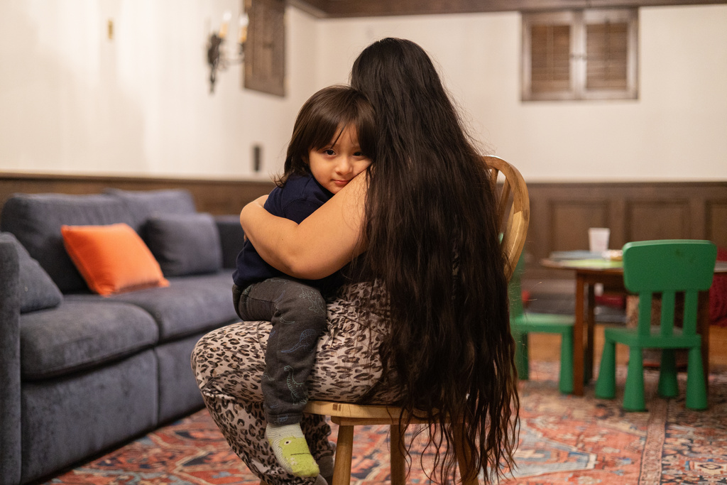 Yair, 3, sits for a portrait with his mom at home Tuesday, Feb. 3, 2026, in Minneapolis. (AP Photo/Liam James Doyle)