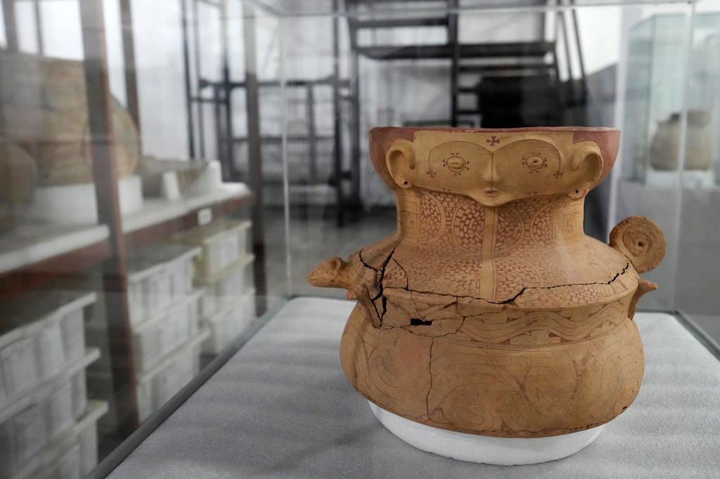 A pottery vessel with anthropomorphic features believed to be an urn is displayed at the Institute for Scientific and Technological Research in Macapa, Amapa state, Brazil, Sunday, March 8, 2026. (AP Photo/Eraldo Peres)