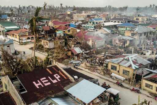 FILE -A 'help' sign is painted on the roof beside damaged homes caused by Typhoon Rai in Siargao island, Surigao del Norte, southern Philippines on, Dec. 22, 2021. (AP Photo/Alren Beronio, File) FILE -A 'help' sign is painted on the roof beside damaged homes caused by Typhoon Rai in Siargao island, Surigao del Norte, southern Philippines on, Dec. 22, 2021. (AP Photo/Alren Beronio, File)