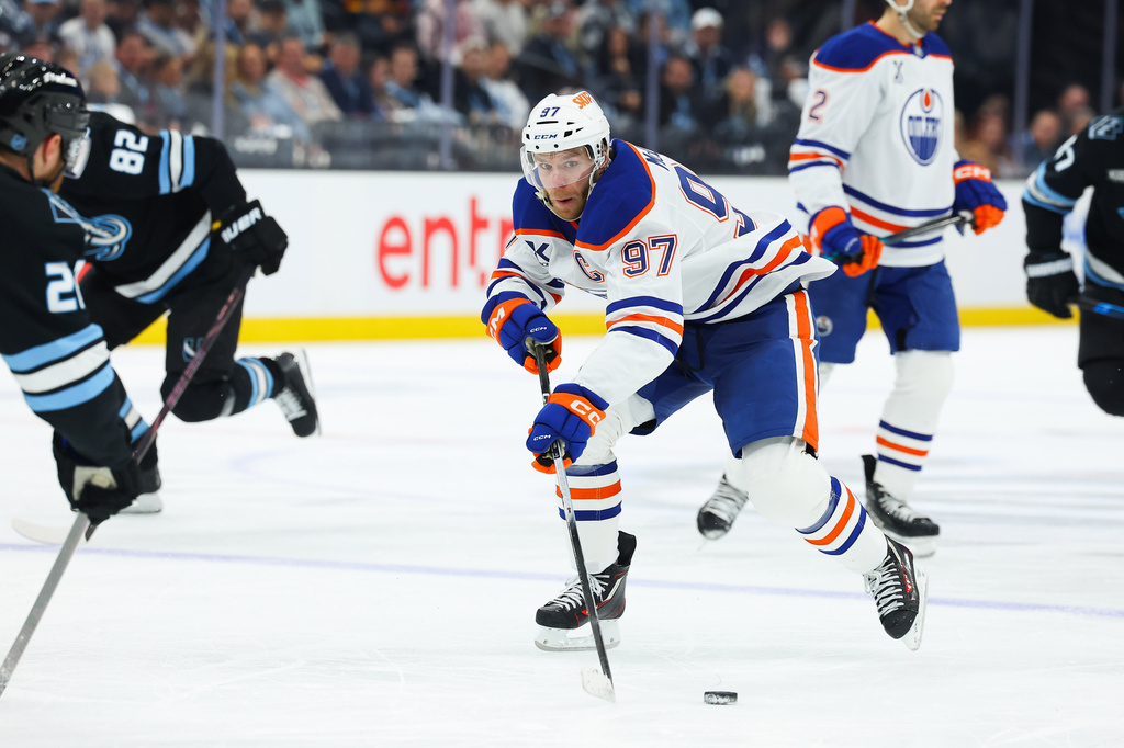 Edmonton Oilers center Connor McDavid (97) goes after the puck against the Utah Mammoth during the second period of an NHL hockey game, Tuesday, April 7, 2026, in Salt Lake City. (AP Photo/Melissa Majchrzak)