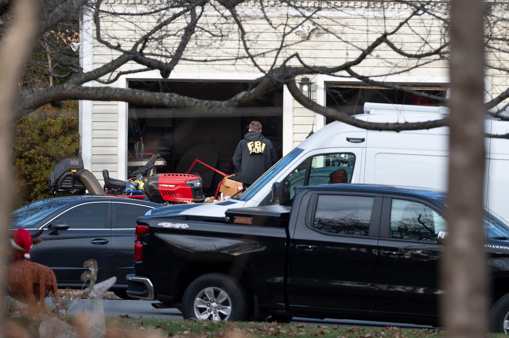A FBI agent enters the garage of the house where they made an arrest, in Woodbridge, Va., Thursday, Dec. 4, 2025. (AP Photo/Cliff Owen)
