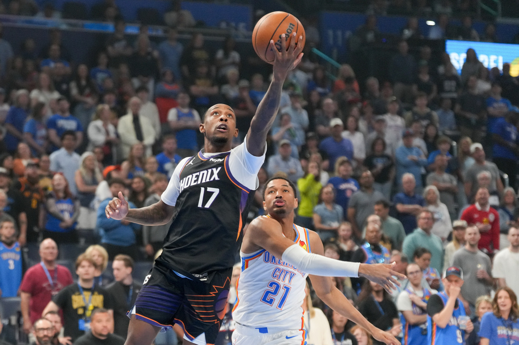 Phoenix Suns guard Jamaree Bouyea (17) looks to shoot in front of Oklahoma City Thunder guard Aaron Wiggins (21) during the first half of an NBA basketball game, Sunday, April 12, 2026, in Oklahoma City. (AP Photo/Kyle Phillips)