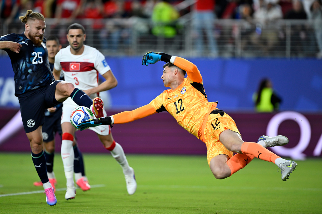 Paraguay goalkeeper Orlando Gill (12) and Isidro Pitta (25) clear the ball during the World Cup Group D soccer match between Turkey and Paraguay in Santa Clara, Calif., near San Francisco, Friday, June 19, 2026. (AP Photo/Eakin Howard)