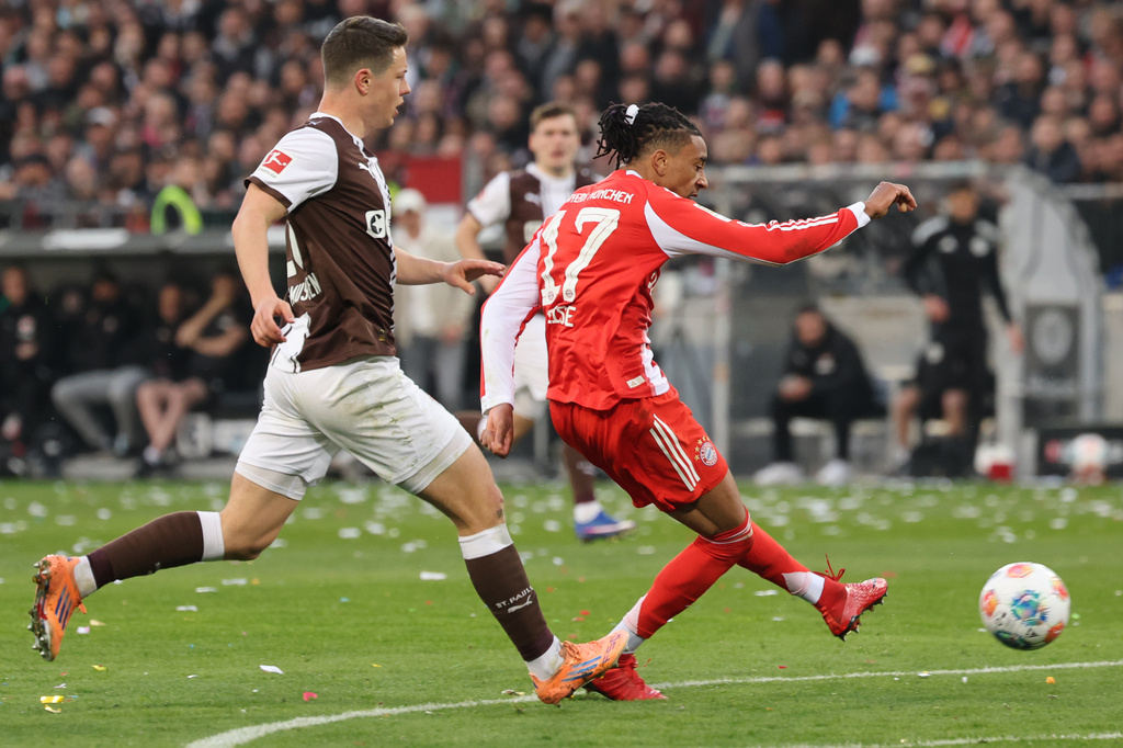 Bayern's Michael Olise, right, scores his side's third goal during the German Bundesliga soccer match between FC St. Pauli and Bayern Munich in Hamburg, Germany, Saturday, April 11, 2026. (Christian Charisius/dpa via AP)