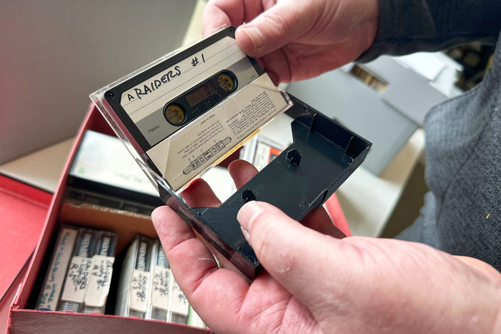 Phil Hallman, a University of Michigan film studies librarian, holds a cassette tape of Lawrence Kasdan and other filmmakers discussing plans for, “Raiders of the Lost Ark,” on Nov. 24, 2025, in Ann Arbor, Mich. (AP Photo/Mike Householder)