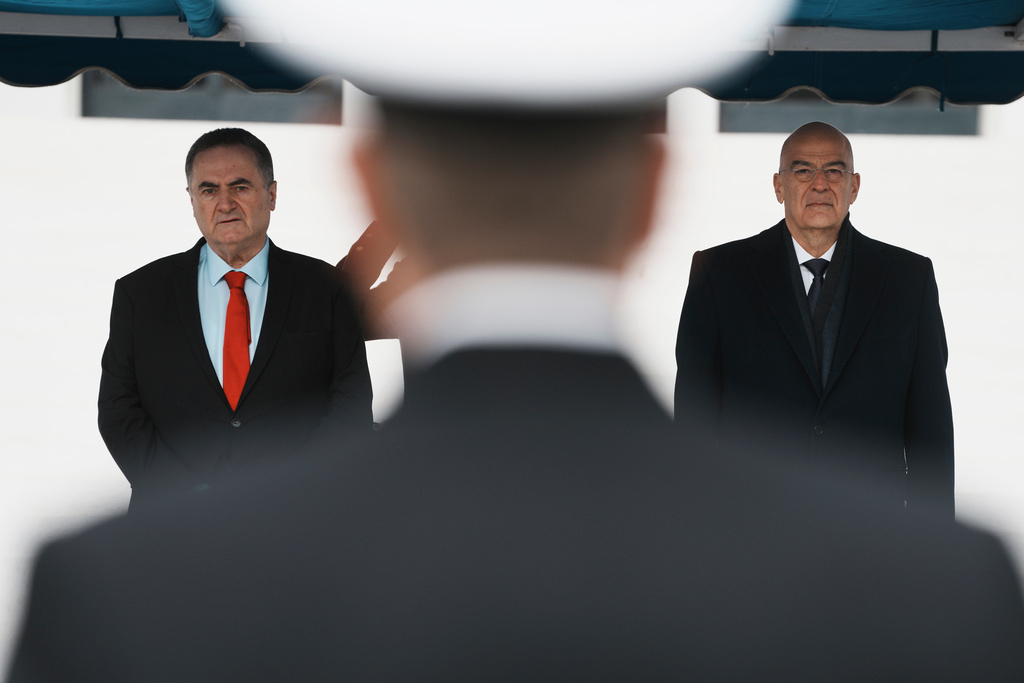 Israeli Defense Minister Israel Katz, left, and his Greek counterpart Nikos Dendias stand for the national anthems in Athens, Greece, Tuesday, Jan. 20, 2026. (AP Photo/Thanassis Stavrakis)