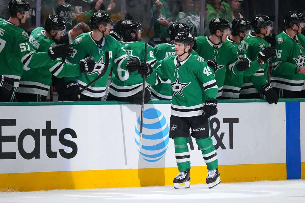 Dallas Stars center Justin Hryckowian skates by his bench after scoring a goal against the Calgary Flames during the second period of an NHL hockey game Tuesday, April 7, 2026, in Dallas. (AP Photo/Julio Cortez)