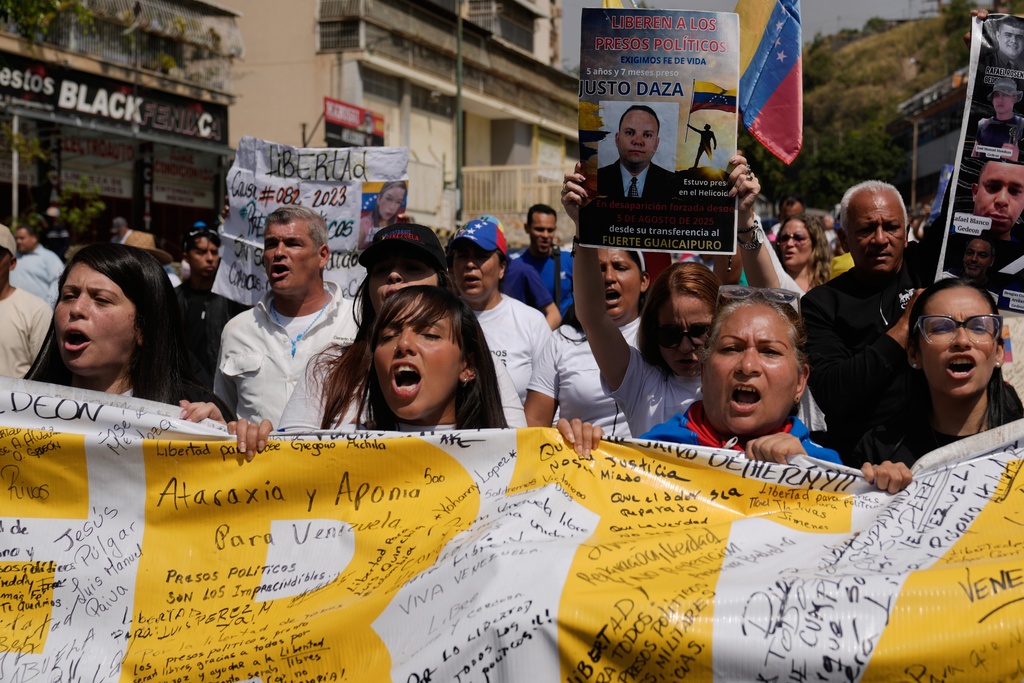 People protest near the Helicoide detention center after the crowd attended a prayer for freedom of political prisoners, peace and reconciliation in Caracas, Venezuela, Saturday, Feb. 7, 2026. (AP Photo/Ariana Cubillos)