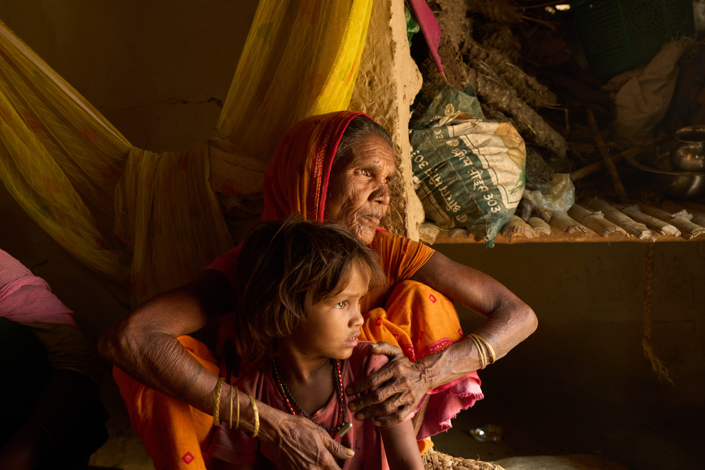 Lachhiya Devi sits with her 5-year-old granddaughter, Sonam Mukhiya, in her home in Gaur, Nepal, on May 19, 2026. Sonam's mother, Kabita Mukhiya, died in December while 28-weeks pregnant amid disruptions to nutrition programs and reproductive outreach services following last year's foreign aid cuts by the United States. (AP Photo/Bram Janssen)
