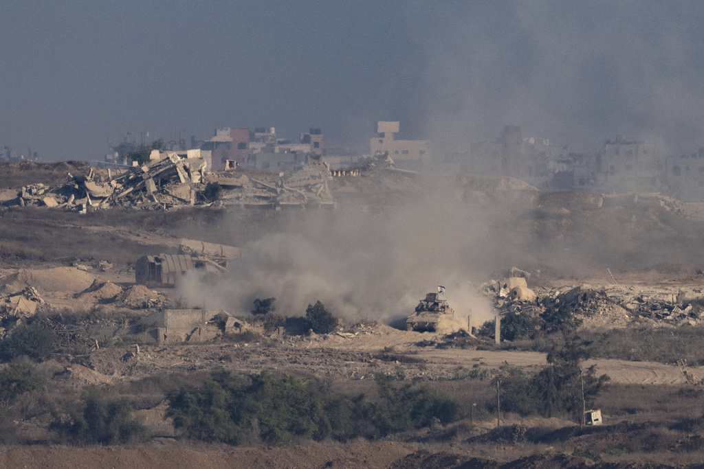 An Israeli armored vehicle moves in an area in the Gaza Strip, as seen from southern Israel, Sunday, Aug. 31, 2025. (AP Photo/Maya Levin)
