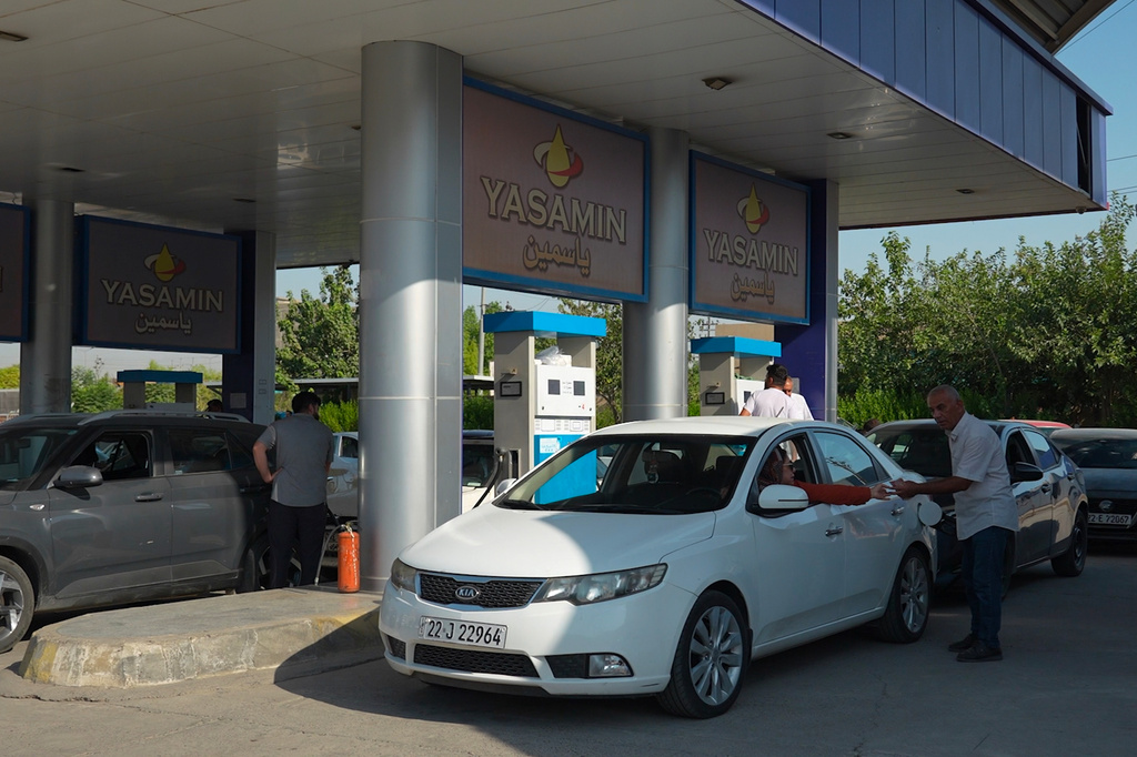 Men pumps gasoline into his car at a gas station during a fuel shortage in Irbil, Iraq, Tuesday, July 28, 2026. (AP Photo/Stella Martany)