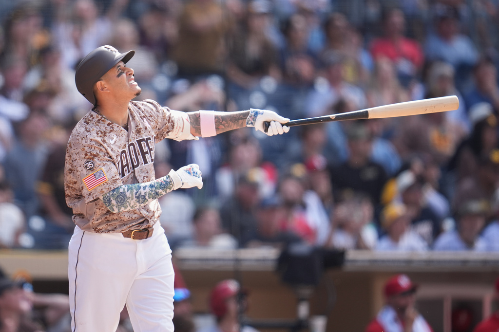 San Diego Padres' Manny Machado watches his walk off sacrifice fly during the tenth inning of a baseball game against the St. Louis Cardinals Sunday, May 10, 2026, in San Diego. San Diego Padres' Nick Castellanos scored from third base on the play. (AP Photo/Gregory Bull)