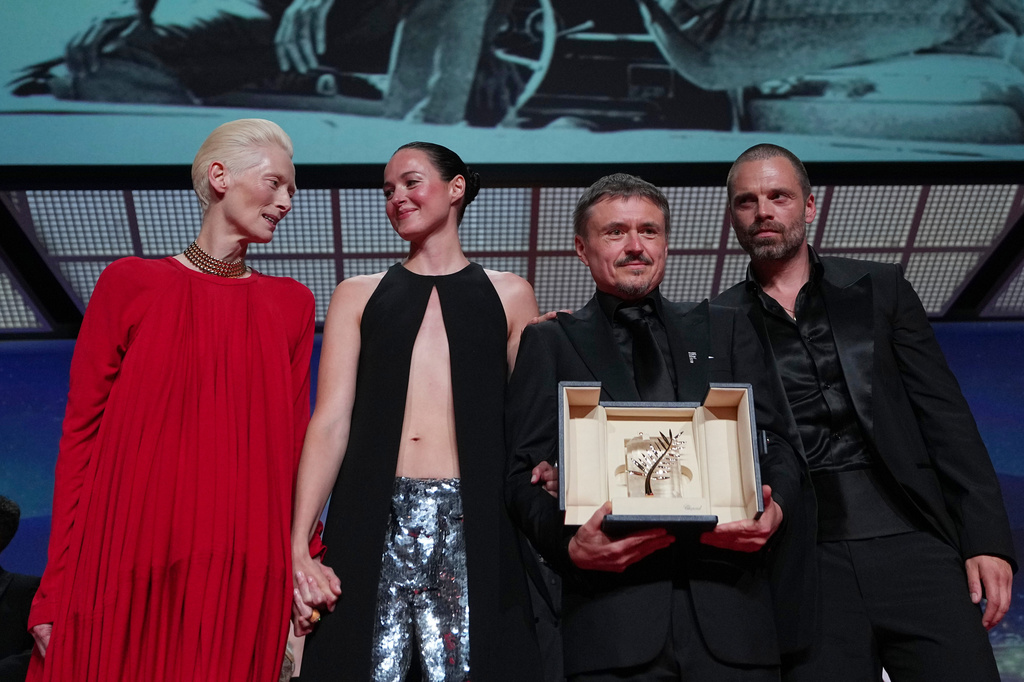 Tilda Swinton, left, poses with Renate Reinsve, Cristian Mungiu, winner of the Palme d'Or for 'Fjord' and Sebastian Stan during the awards ceremony at the 79th international film festival, Cannes, southern France, Saturday, May 23, 2026. (AP Photo/Andreea Alexandru)