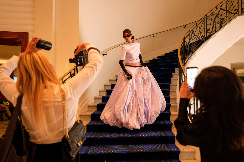 A woman poses for photographers in the Hotel Martinez during the 79th international film festival, Cannes, southern France, Tuesday, May 19, 2026. (AP Photo/Andreea Alexandru)