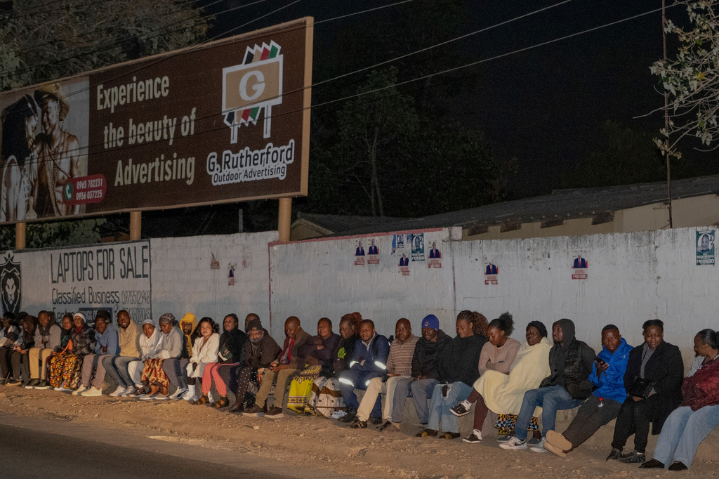Zambians queue outside a polling station on the outskirts of Lusaka, Zambia, Thursday, Aug. 13, 2026. (AP Photo/Anita Reed)