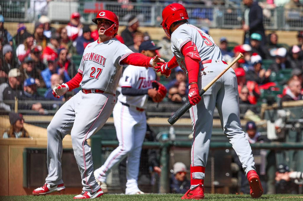 Cincinnati Reds' Sal Stewart (27) celebrates with Rece Hinds (57) after scoring during the second inning of a baseball game against the Minnesota Twins, Saturday, April 18, 2026, in Minneapolis. (AP Photo/Ellen Schmidt)