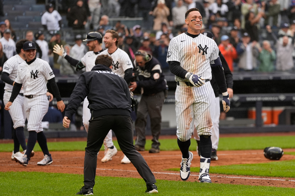 New York Yankees' Aaron Judge, right, reacts after hitting a two-run walk-off home run during the ninth inning of a baseball game against the Tampa Bay Rays, Sunday, May 24, 2026, in New York. (AP Photo/Seth Wenig)