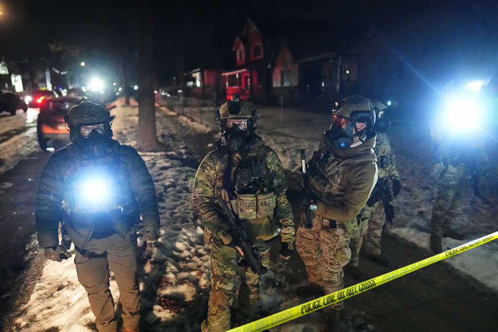 FILE - Law enforcement officers at the scene of a reported shooting Wednesday, Jan. 14, 2026, in Minneapolis. (AP Photo/Adam Gray, File)