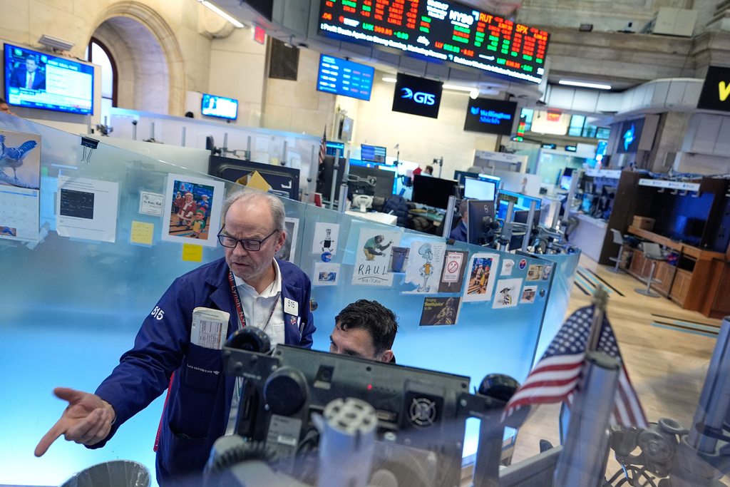 David O'Day, left, works on the floor at the New York Stock Exchange in New York, Wednesday, March 18, 2026. (AP Photo/Seth Wenig)