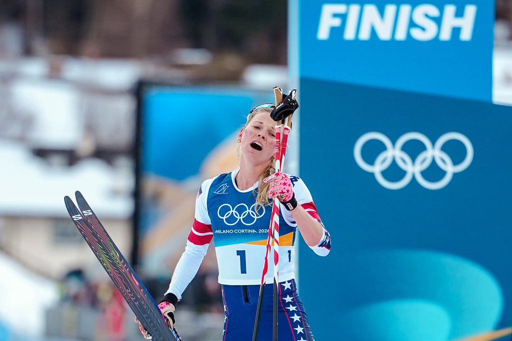 Jessie Diggins of the United States catches her breath after crossing the finish line in the cross country skiing women's 10km + 10km skiathlon at the 2026 Winter Olympics, in Tesero, Italy, Saturday, Feb. 7, 2026. (AP Photo/Matthias Schrader)