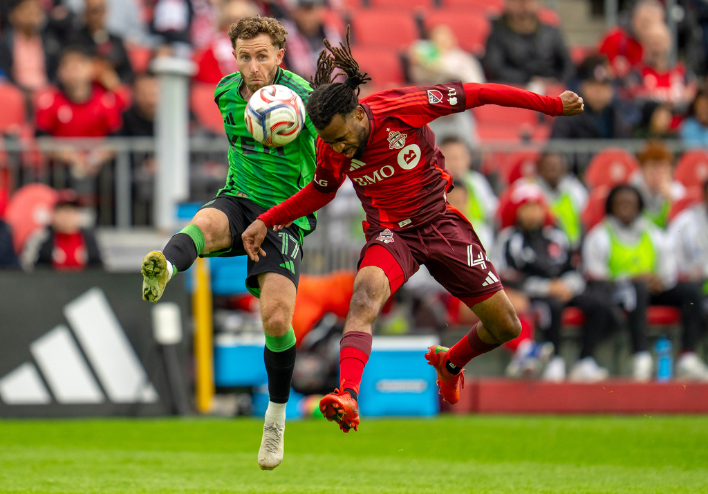 Toronto FC's Raheem Edwards (44) and Austin FC's Jon Gallagher (17) battle for the ball during the first half of an MLS soccer game in Toronto, Saturday, April 18, 2026. (Frank Gunn/The Canadian Press via AP)
