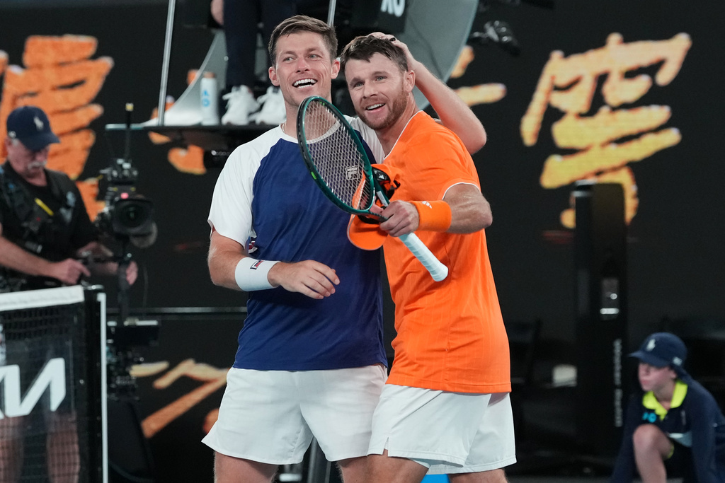 Christian Harrison of the U.S. and Neal Skupski, left, of Britain celebrate after defeating Australia's Jason Kubler and Marc Polmans in the men's doubles final at the Australian Open tennis championship in Melbourne, Australia, Saturday, Jan. 31, 2026. (AP Photo/Aaron Favila)