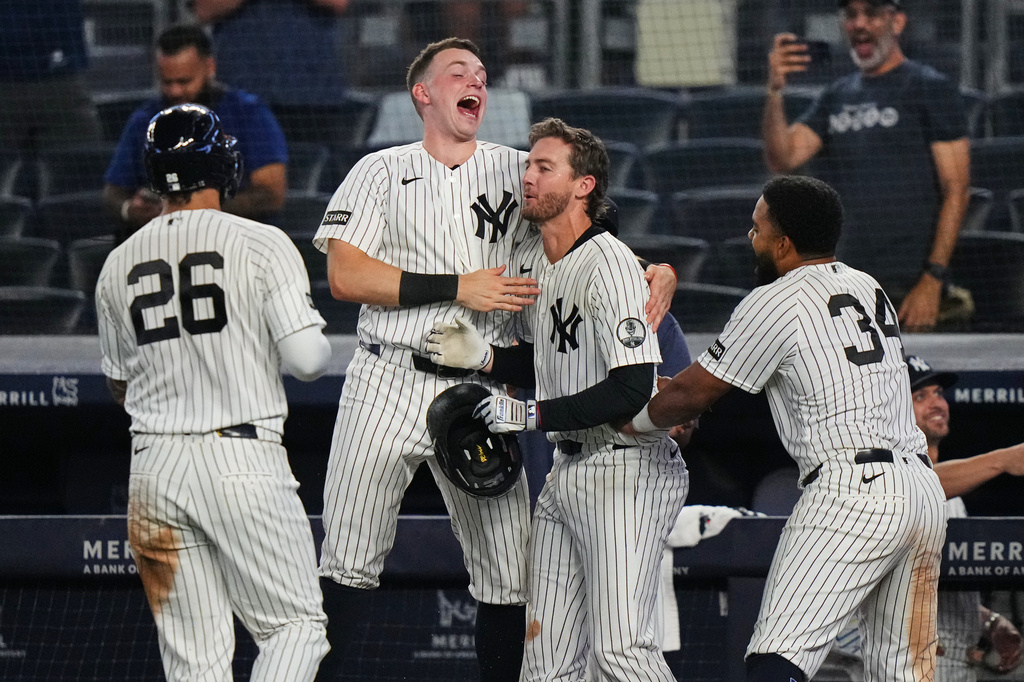 New York Yankees' Ryan McMahon, center, celebrates with Heliot Ramos, right, Ben Rice, second from left, and Luis García Jr. after a baseball game against the Atlanta Braves Saturday, Aug. 8, 2026, in New York. (AP Photo/Frank Franklin II)