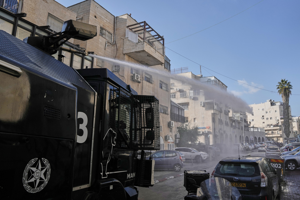 Israeli police shoot a water canon as they work to restore order during a violent disturbance by Ultra-Orthodox Jewish protesters in Jerusalem, Thursday, Dec. 18, 2025. (AP Photo/ Mahmoud Illean)
