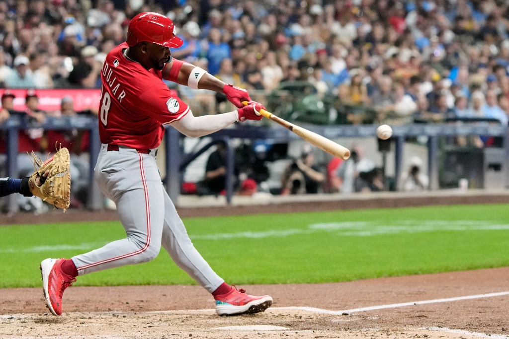 Cincinnati Reds' Miguel Andujar hits a double during the third inning of a baseball game against the Milwaukee Brewers Saturday, Sept. 27, 2025, in Milwaukee. (AP Photo/Morry Gash)