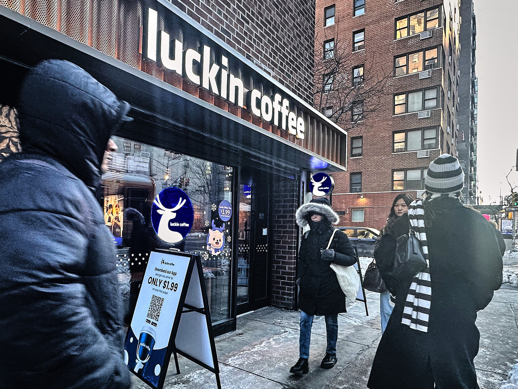 Pedestrians pass a Luckin Coffee store in New York, Friday, Jan. 30, 2026. (AP Photo/Richard Drew)