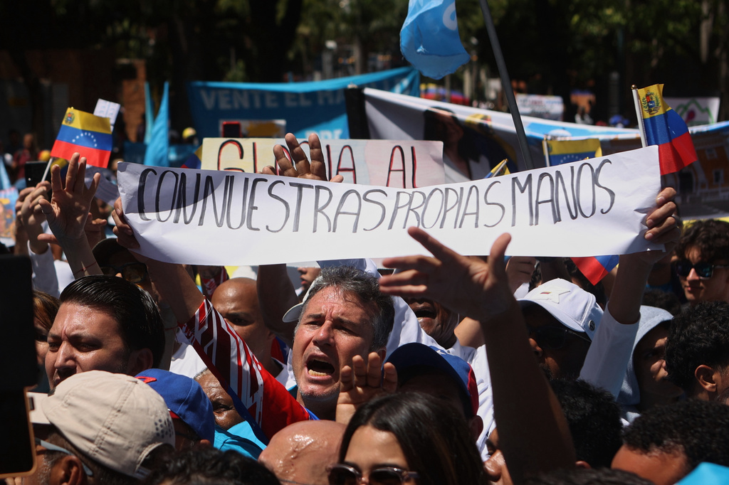 Supporters of opposition leader María Corina Machado mark the second anniversary of the disputed 2024 presidential election in Caracas, Venezuela, Tuesday, July 28, 2026. (AP Photo/Pedro Mattey)