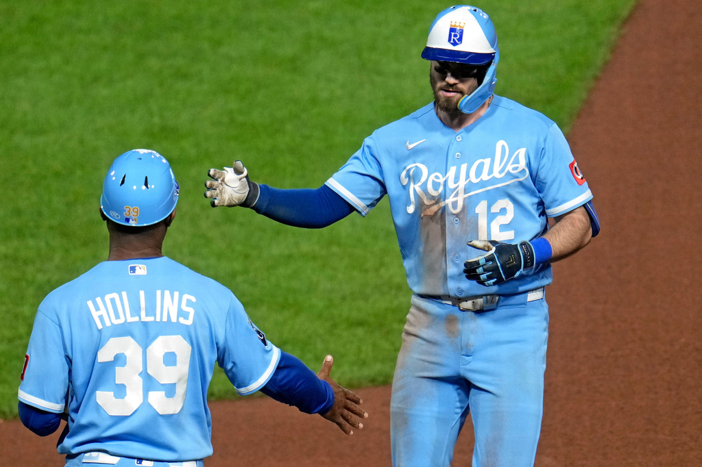 Kansas City Royals' Nick Loftin (12) celebrates with first base coach Damon Hollins (39) after driving in a run with a single off Pittsburgh Pirates pitcher Camilo Doval during the seventh inning of a baseball game in Pittsburgh, Saturday, Sept. 19, 2026. (AP Photo/Gene J. Puskar)