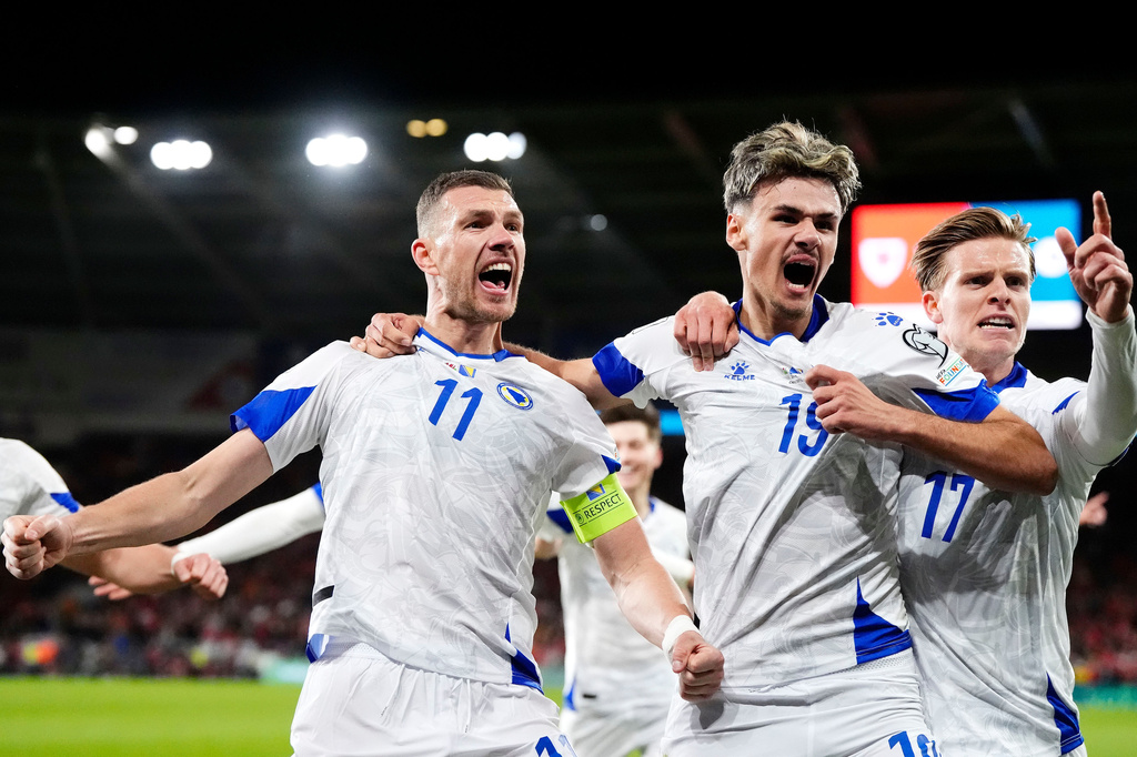 Bosnia and Herzegovina's Edin Dzeko, left, celebrates with team-mates after scoring their side's first goal during the World Cup playoff semifinal soccer match between Wales and Bosnia and Herzegovina in Cardiff, Wales, Thursday, March 26, 2026. (Nick Potts/PA via AP)