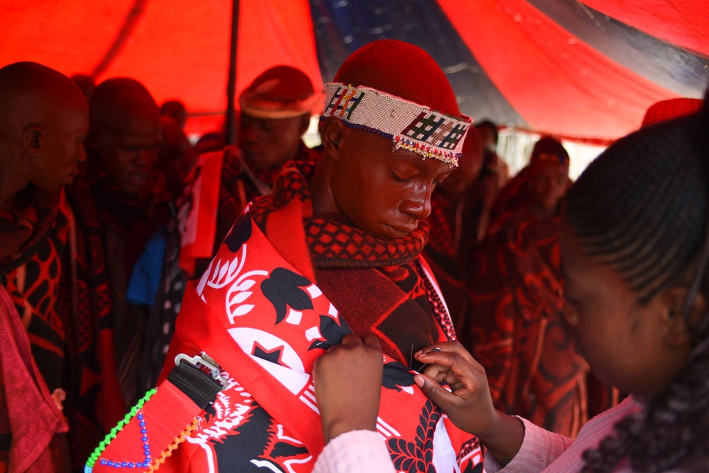 An initiate is wrapped in a cloth after returning from a traditional initiation school in Phuthaditjhaba, South Africa, Saturday, Jan. 3, 2026. (AP Photo/Alfonso Nqunjana)
