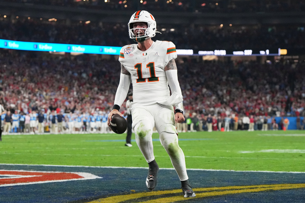 Miami quarterback Carson Beck scores a touchdown during the second half of the Fiesta Bowl NCAA college football playoff semifinal game against Mississippi, Thursday, Jan. 8, 2026, in Glendale, Ariz. (AP Photo/Rick Scuteri)