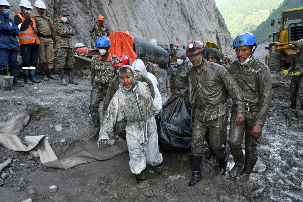 In this handout photograph provided by the Nepal Army, Nepalese soldiers carry the bodies of workers recovered during a search and rescue operation at the Chilime hydropower project following earlier flash floods in Nepal's Rasuwa district, Wednesday, Sept. 16, 2026. (Nepal Army via AP)
