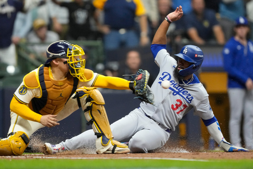 Los Angeles Dodgers' Teoscar Hernández is forced out at home by Milwaukee Brewers catcher William Contreras during the fourth inning in Game 1 of baseball's National League Championship Series, Monday, Oct. 13, 2025, in Milwaukee. (AP Photo/Brynn Anderson) Los Angeles Dodgers' Teoscar Hernández is forced out at home by Milwaukee Brewers catcher William Contreras during the fourth inning in Game 1 of baseball's National League Championship Series, Monday, Oct. 13, 2025, in Milwaukee. (AP Photo/Brynn Anderson)