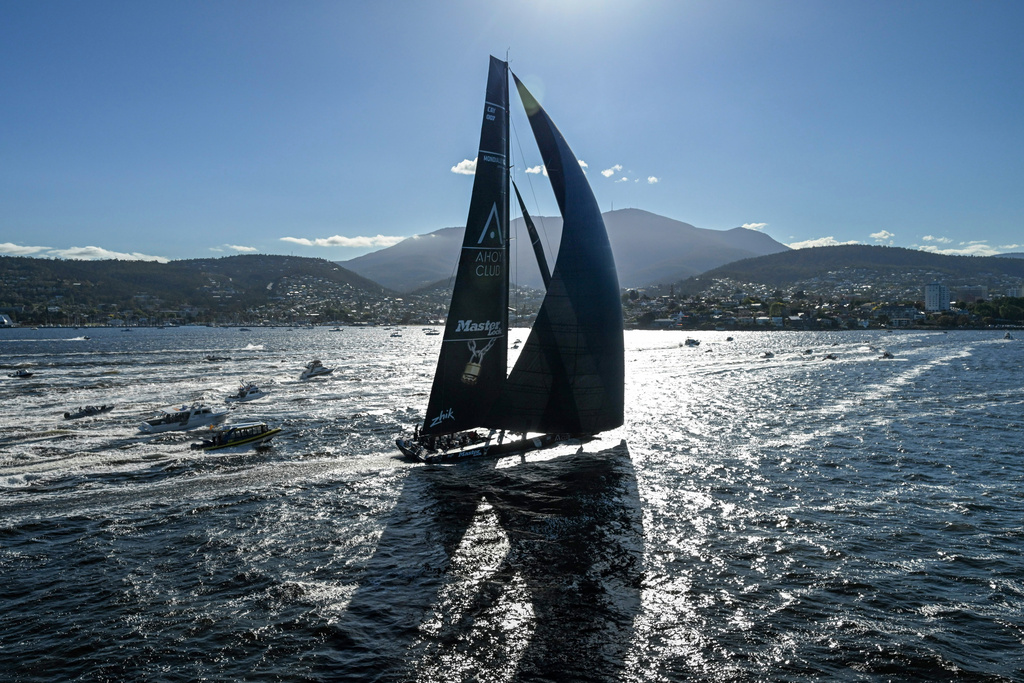 In this photo provided by the Cruising Yacht Club of Australia Comanche crosses the finish line in Hobart, Australia, Sunday, Dec. 28, 2025, to claim line honors in the Sydney Hobart yacht race. (Kurt Arrigo/CYCA via AP)