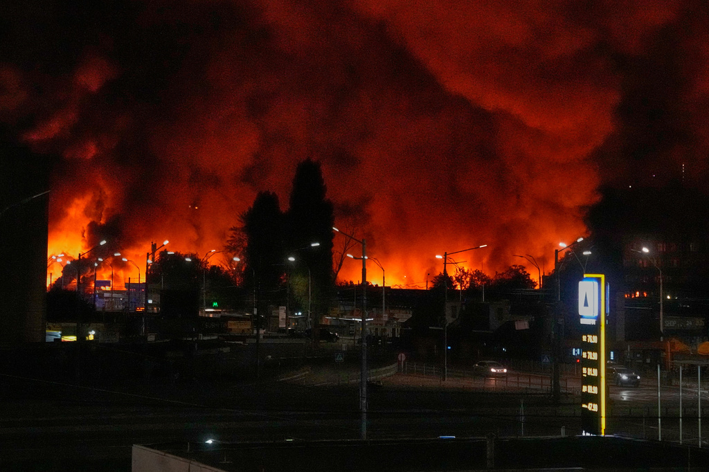 FILE - A fire burns at the book market following a Russian missile attack in Kyiv, Ukraine, Aug. 16, 2026. (AP Photo/Efrem Lukatsky, File)