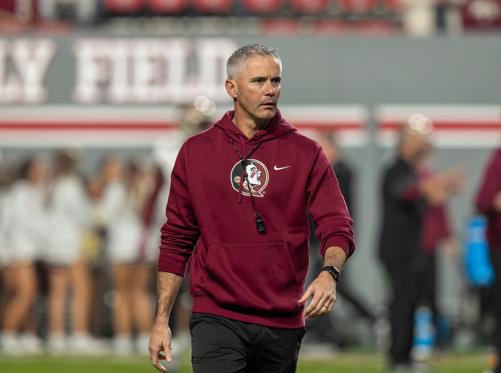 Florida State head coach Mike Norvell walks on the field during the first half of an NCAA college football game against North Carolina State, Friday, Nov. 21, 2025, in Raleigh, N.C. (AP Photo/David Yeazell)
