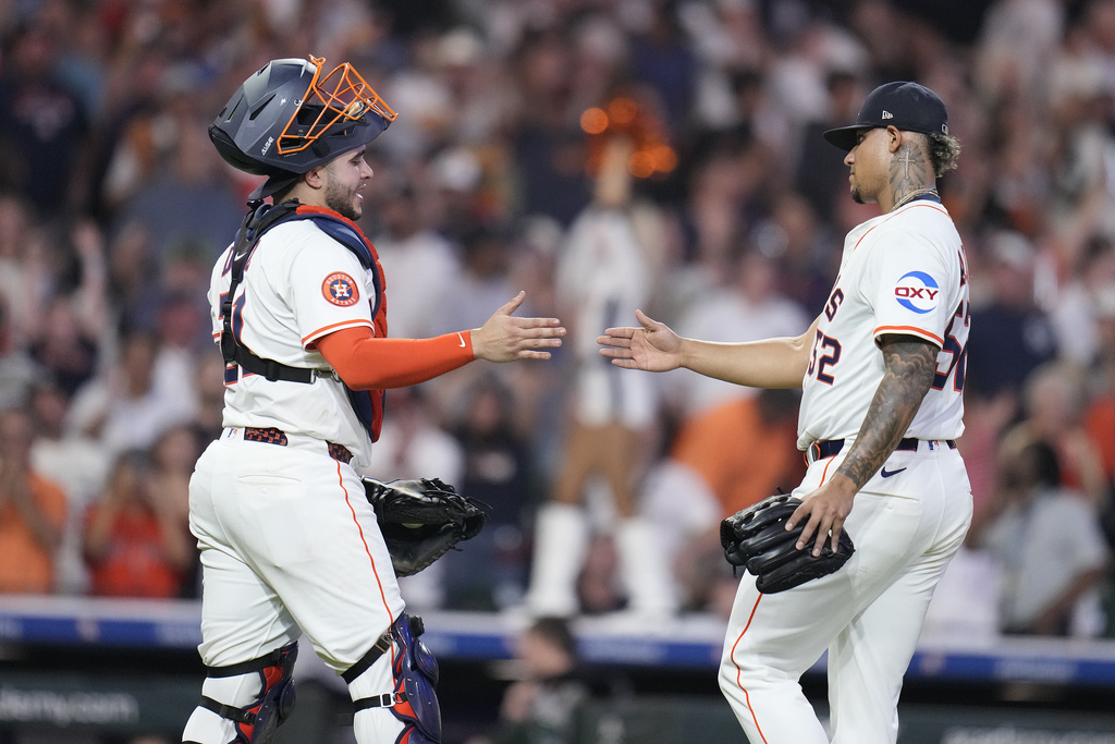 Houston Astros relief pitcher Bryan Abreu, right, celebrates with Houston Astros catcher Yainer Diaz, left, after their win over the New York Yankees during the ninth inning of a baseball game Wednesday, Sept. 3, 2025, in Houston. (AP Photo/Karen Warren)