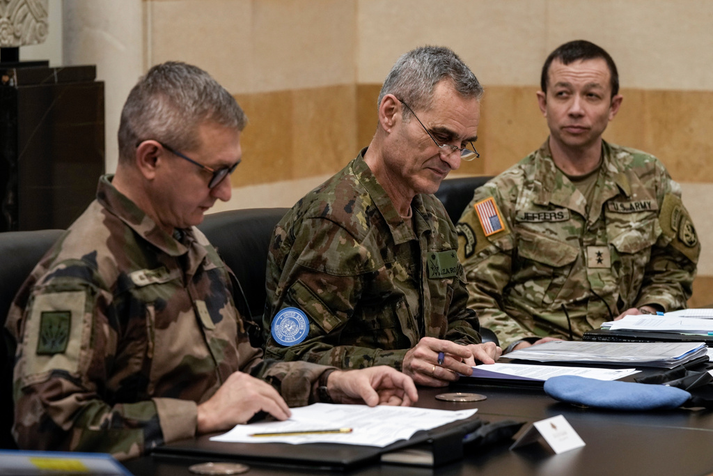 FILE - Members of the committee monitoring the Lebanon-Israel ceasefire, the Head of Mission and Force Commander of the United Nations Interim Force in Lebanon (UNIFIL), Major General Aroldo Lazaro Saenz of Spain, center, US Maj. Gen. Jasper Jeffers, right, and Gen. Guillaume Ponchamp of France, left, meet with Lebanese caretaker Prime Minister Najib Mikati, at the government palace in Beirut, Lebanon, Tuesday, Dec. 24, 2024. (AP Photo/Bilal Hussein, File)
