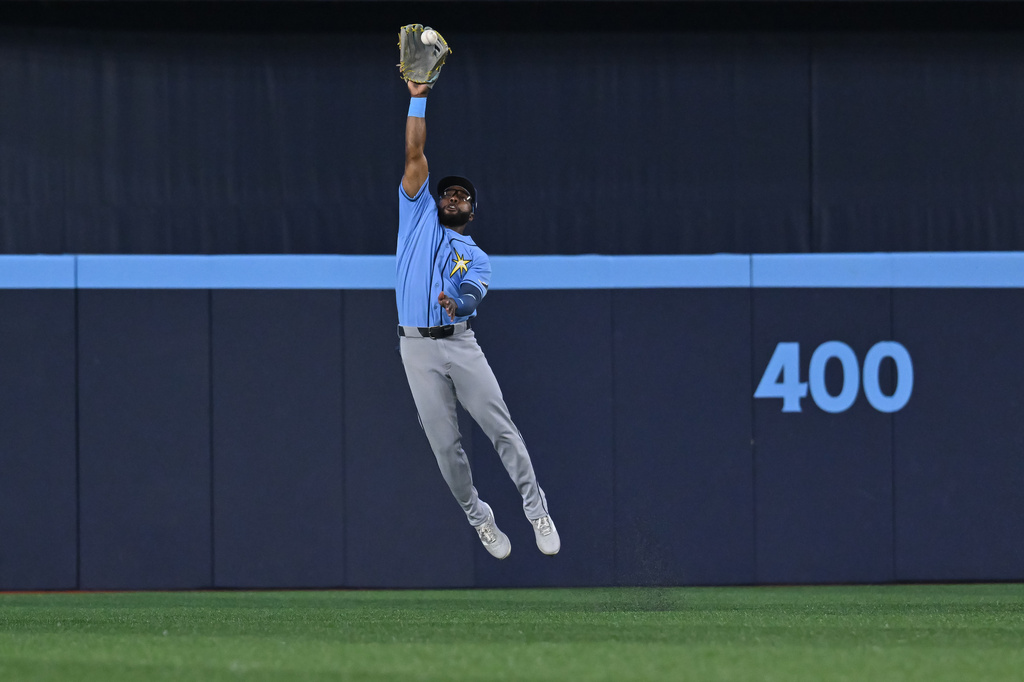 Tampa Bay Rays centre fielder Cedric Mullins (31) fields a ball off the bat of Toronto Blue Jays' Ernie Clement for a single during the first inning of a baseball game in Toronto on Tuesday, July 21, 2026. (Jon Blacker/The Canadian Press via AP)