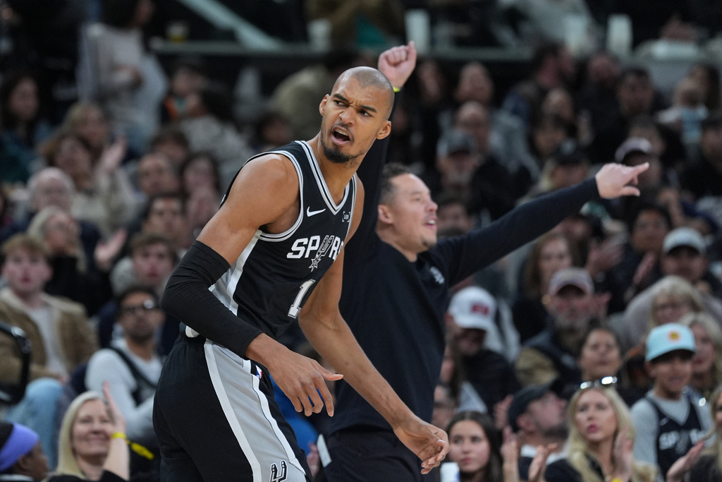 San Antonio Spurs forward Victor Wembanyama (1) reacts after scoring against the Minnesota Timberwolves during the second half of an NBA basketball game in San Antonio, Saturday, Jan. 17, 2026. (AP Photo/Eric Gay)