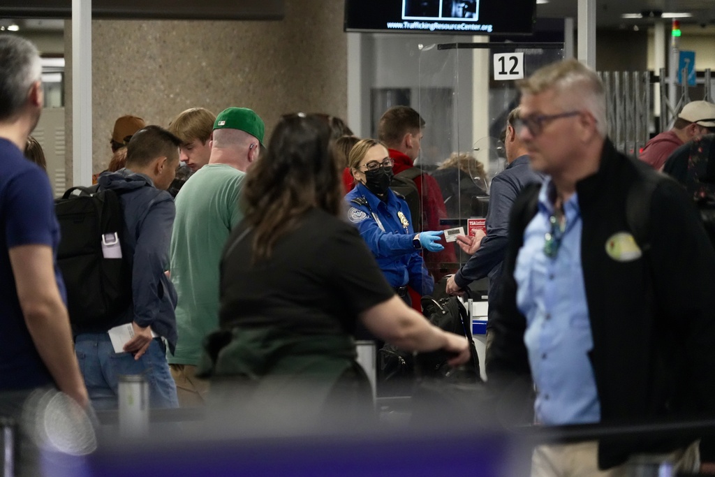 A TSA staff member security walking past a check point at Harry Reid International Airport, Saturday, March 21, 2026, in Las Vegas. (AP Photo/Ty ONeil)