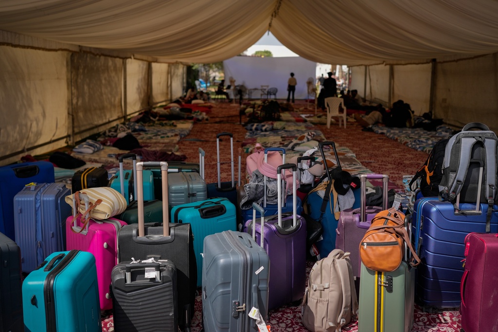 Suitcases belonging to stranded foreign travelers are seen at a farmhouse owned by an Indian businessman, now converted into a shelter in Ajman, near Dubai, United Arab Emirates, Saturday, March 7, 2026. (AP Photo/Altaf Qadri)