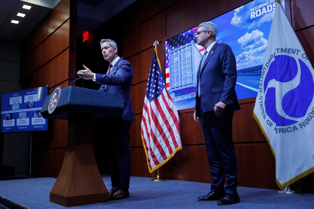 U.S. Transportation Secretary Sean Duffy speaks beside Federal Motor Carrier Safety Administrator Derek Barrs during a news conference on enhancing truck driving safety at the U.S. Department of Transportation on Friday, Feb. 20, 2026, in Washington. (AP Photo/Tom Brenner)