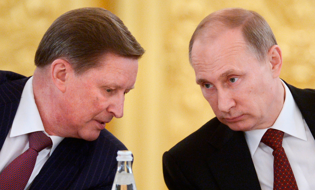 FILE- Russian President Vladimir Putin, right, listens to his chief of staff Sergei Ivanov during a meeting in the Kremlin in Moscow, on Monday, March 24, 2014.(Alexei Nikolsky, Sputnik, Kremlin Pool Photo via AP)