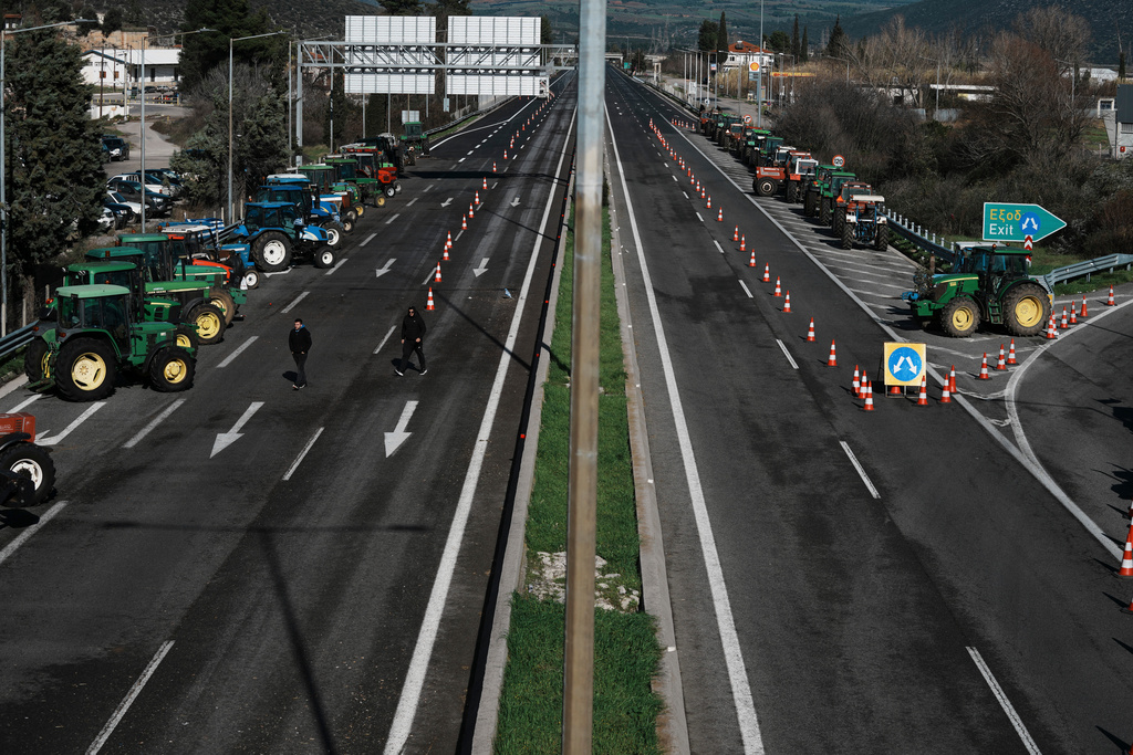Tractors block a highway as farmers protest in Kastro, about 130 kilometers (81 miles) north of Athens, Greece, over delays in the payment of European Union-backed agricultural subsidies, on Thursday, Jan. 8 2025. (AP Photo/Thanassis Stavrakis)