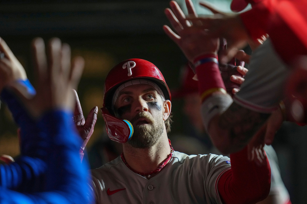 Philadelphia Phillies' Bryce Harper (3) celebrates after hitting a two-run home run during the eighth inning of a baseball game against the Chicago Cubs, Tuesday, April 21, 2026, in Chicago. (AP Photo/Erin Hooley)